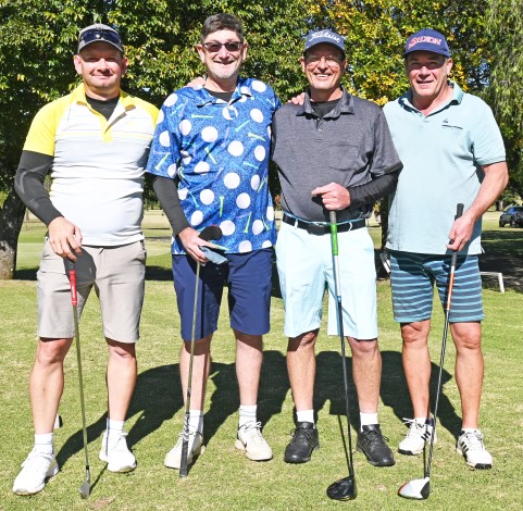 Four golfers photographed in their golfing attire on a golf coarse.