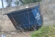 A blue municipal skip bin standing outside.