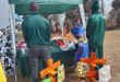 An image of two Inkanyiso Special School learners standing next to the items they hand-made at their Market Day.