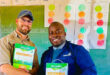 An image of Ruan Nel from AFGRI standing next to principal of Nkwambazi Primary School Zakhele Xulu as Ruan handed over garden equipment and supplies to the school.