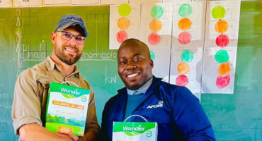 An image of Ruan Nel from AFGRI standing next to principal of Nkwambazi Primary School Zakhele Xulu as Ruan handed over garden equipment and supplies to the school.