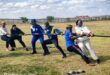 Image of youth and police officers participating in tug-o-war.
