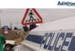 A large photo of a police van. People are spotted in the background by a padestrian crossing.