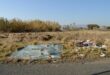 Image of dumped building rubble and shattered glass in a field on Albert Street, Dundee.