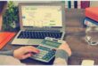 Image of a calculator and laptop.