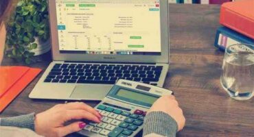 Image of a calculator and laptop.