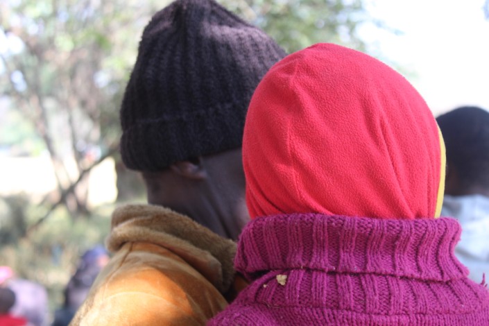 A father and his son are visibily distressed while waiting for help to get back to Malawi.