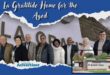 A photo of the La Gratitude home for the Aged Committee with the home in the background. there is also an inset image of the La Gratitude Cottages. The entire image is bordered by a bold blue banner with bold white text and the Newcastle Advertiser logo.