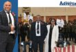 A celebration is photographed inside a school hall, wishing its school principal farewell.
