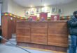 Image of three men in council chambers.