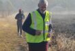 Image of a runner with a reflective jacket on a parkrun course.