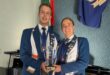 Image of head girl and head boy of Hoërskool Pionier holding a trophy.