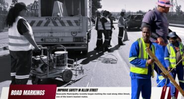 A black and white main background image of municipal workers and their machinery along a busy town route. in the foreground is colour images of municipal workers as well as a bold red and white banner with bold black text.