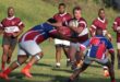 Image of two rugby teams, one attacking while the other defend.