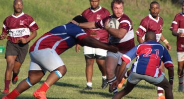 Image of two rugby teams, one attacking while the other defend.