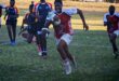 Image of a rugby player with ball in hand on his way to the try line.