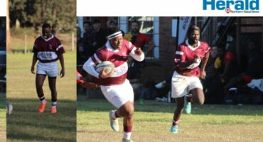 Image of rugby players running with ball.