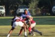 Image of a Sentraal rugby player being tackled by two Vryheid players.