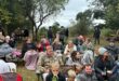 Image of people sitting outside with blankets.