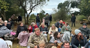 Image of people sitting outside with blankets.