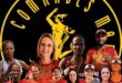 Image of athletes with their Comrades shirts and medals in front of the Comrades emblem.