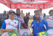 An image of AbaQulusi Community Radio Station Manager, Busi Thusini handing out a trophy and sport kit to a player after the AbaQulusi FM Soccer Spectacular games held on Youth Day in Bhekuzulu.