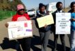 People holding placards condemning drug abuse, GBV and teenage pregnancy.