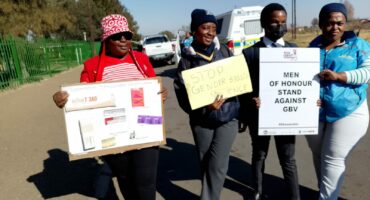 People holding placards condemning drug abuse, GBV and teenage pregnancy.
