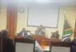 Image of councillors and officials around a horseshoe table in Endumeni Council Chamber.