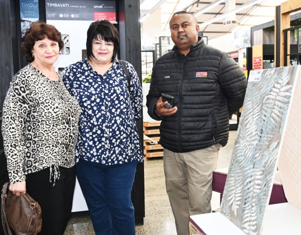 Three people pose inside a newly revamped Newcastle CTM.