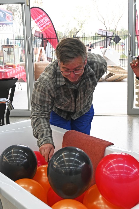 A man is pictured playing a pop-a-balloon game at the Newcastle CTM store.
