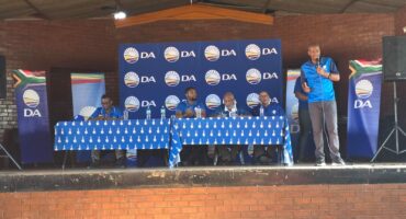 Image of DA provincial leader Sithembiso Ngema standing on a stage addressing a meeting.