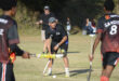 Image of hockey players in action with one player with the ball.