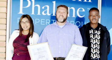 Image of Dormehl Phalane estate agents standing outside the Dundee office with certificates.