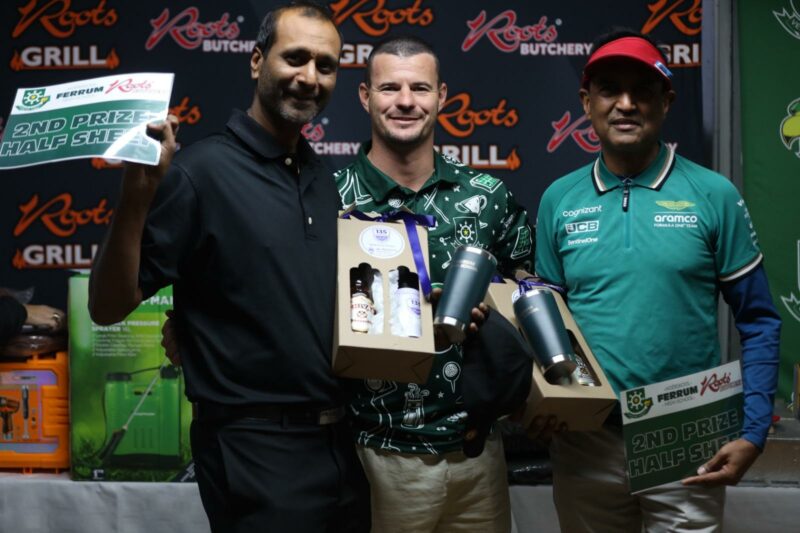 A photo of the winners of a gold day taken infront of a roots butchery banner.