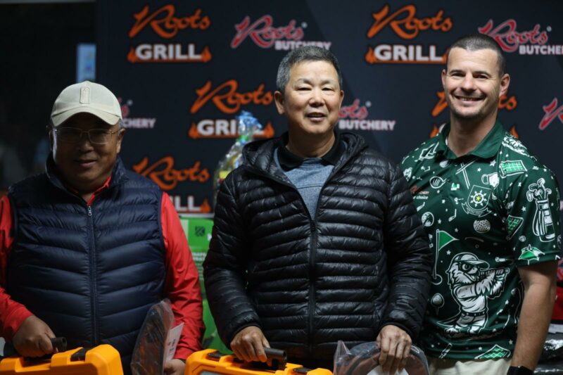 A photo of the winners of a gold day taken infront of a roots butchery banner.