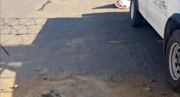 Image of pot-holes fixed on a Dundee road with a bakkie parked adjacent.