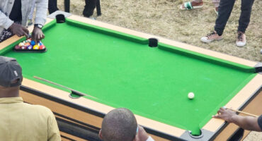 Image of people around a pool table in a street in Dundee.
