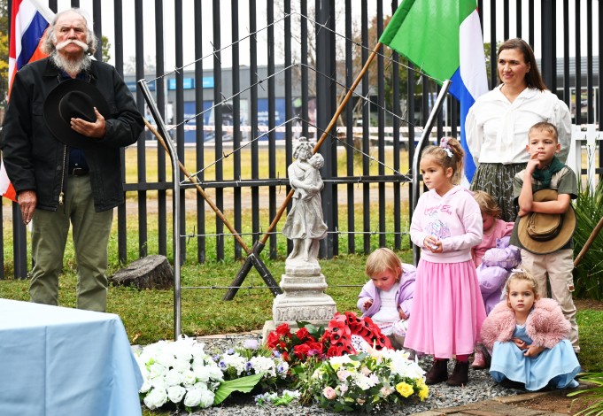 A family is photographed in historical attire paying tribute at a momument erected in remembereance of the lost women and children of the Anglo-Boer War