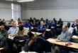 Photo of local business people in the Endumeni area meeting with SAPS officials in a lecture hall.