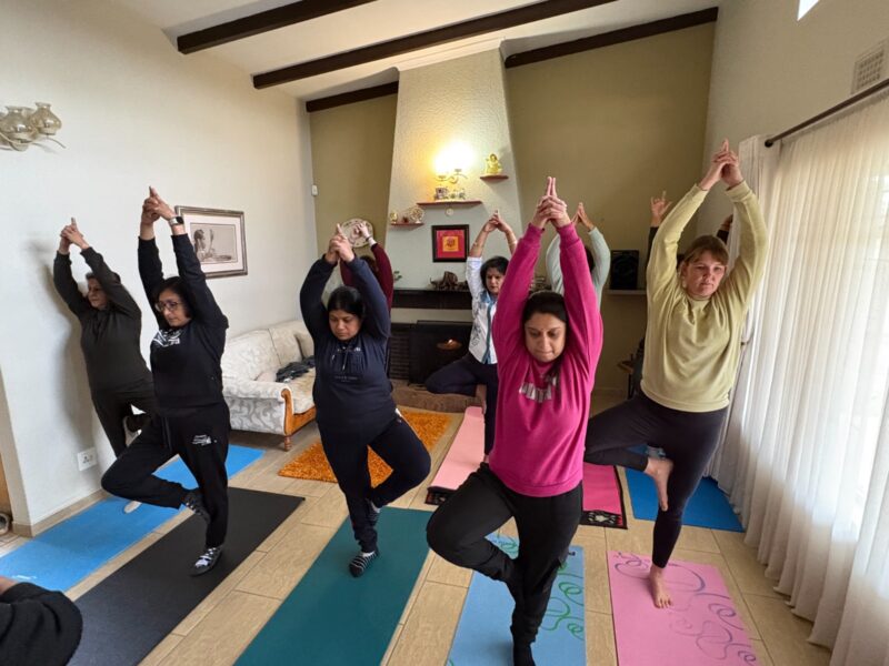 A large photo of a group of women doing a yoga pose.
