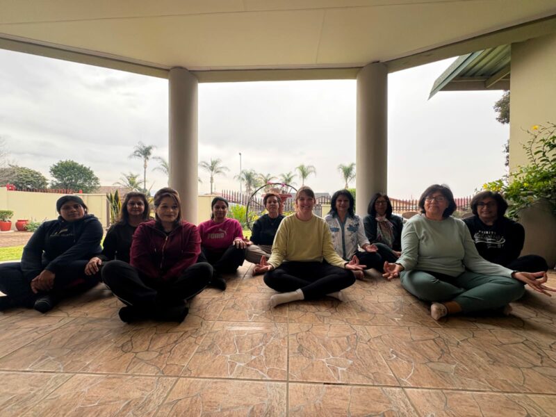 A large photo of a group of women doing a yoga pose.