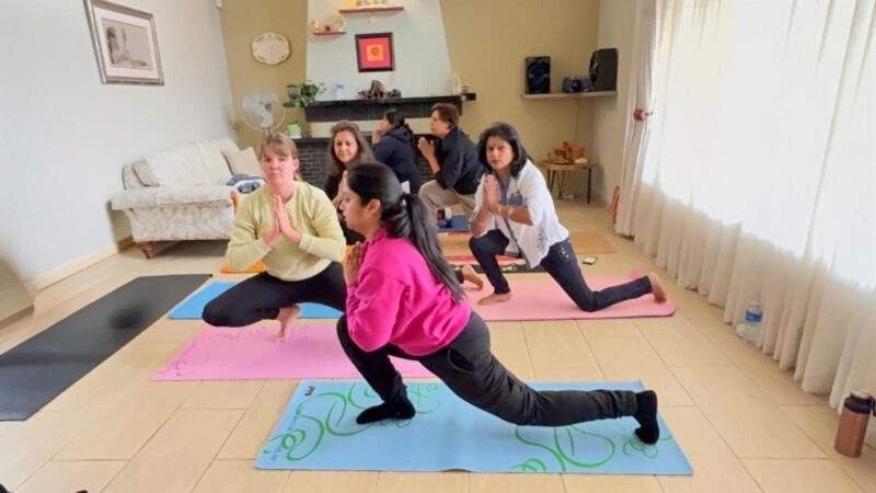A large photo of a group of women doing a yoga pose.