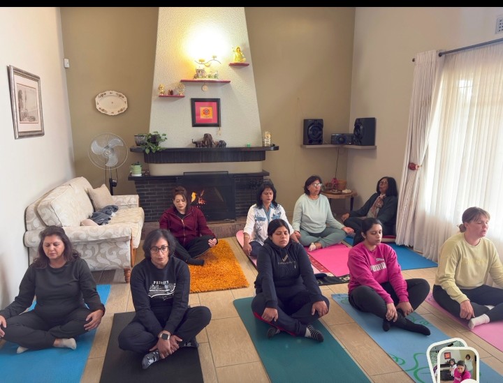 A large photo of a group of women doing a yoga pose.