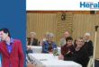 Image of elderly people watching as Andrew Mills sings.