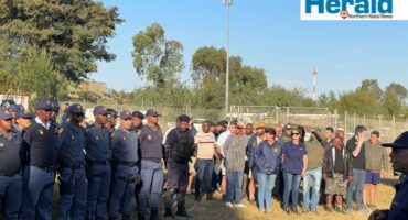 Image of police and other law enforcement agencies gathered before a convoy.