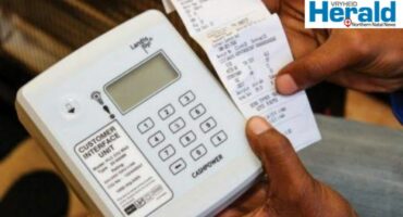 Image of electricity meter and a hand holding a ticket.