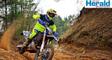 Image of motorcycle rider on a dirt road during an enduro competition.