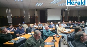Image of people sitting in the council chambers.