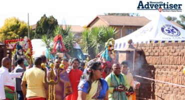 A group of people taking part in a Hindu Religious Festival.